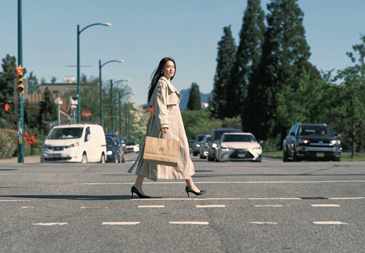 Woman with shopping bag crossing street